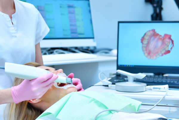 Woman dentist scaning patient’s teeth